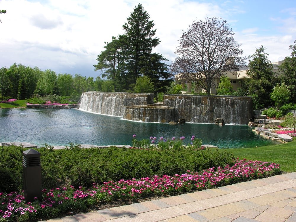 large cascading waterfall with patio overlooking man-made
