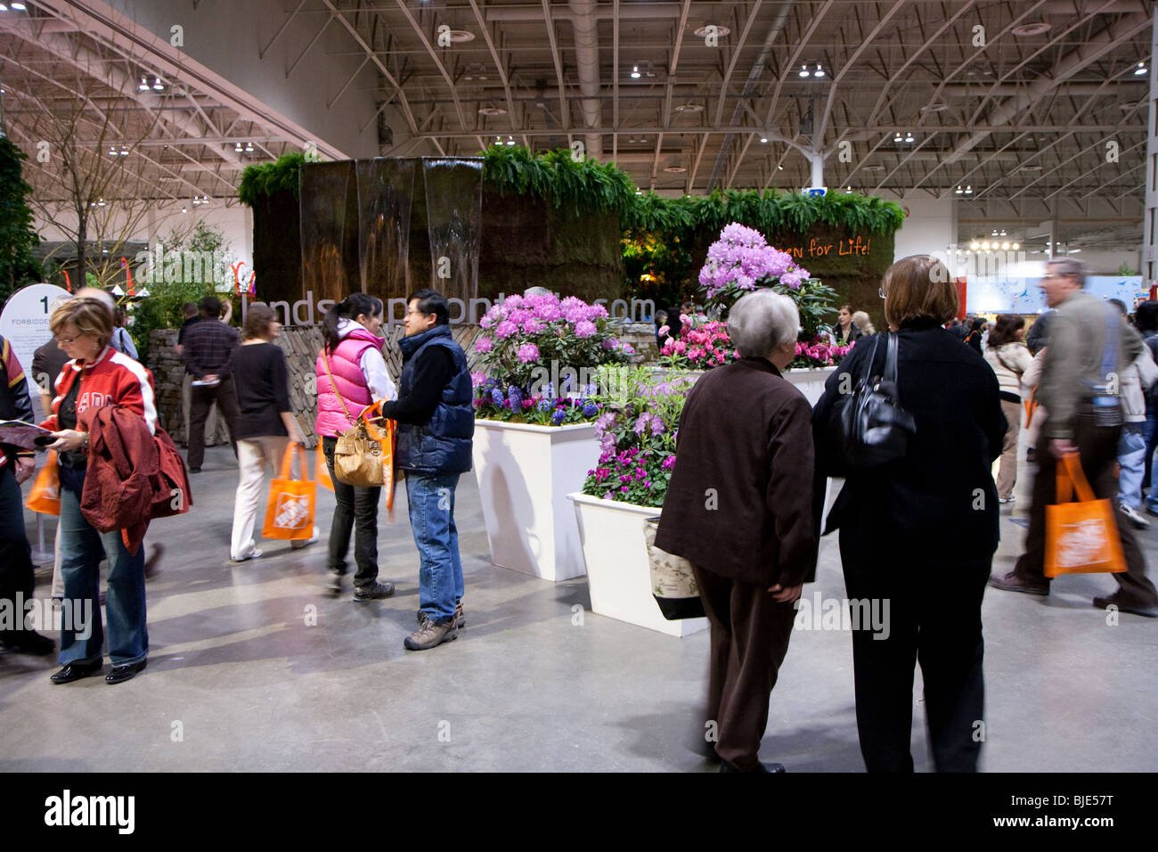 visitors carrying home depot orange reusable bags at the flower and