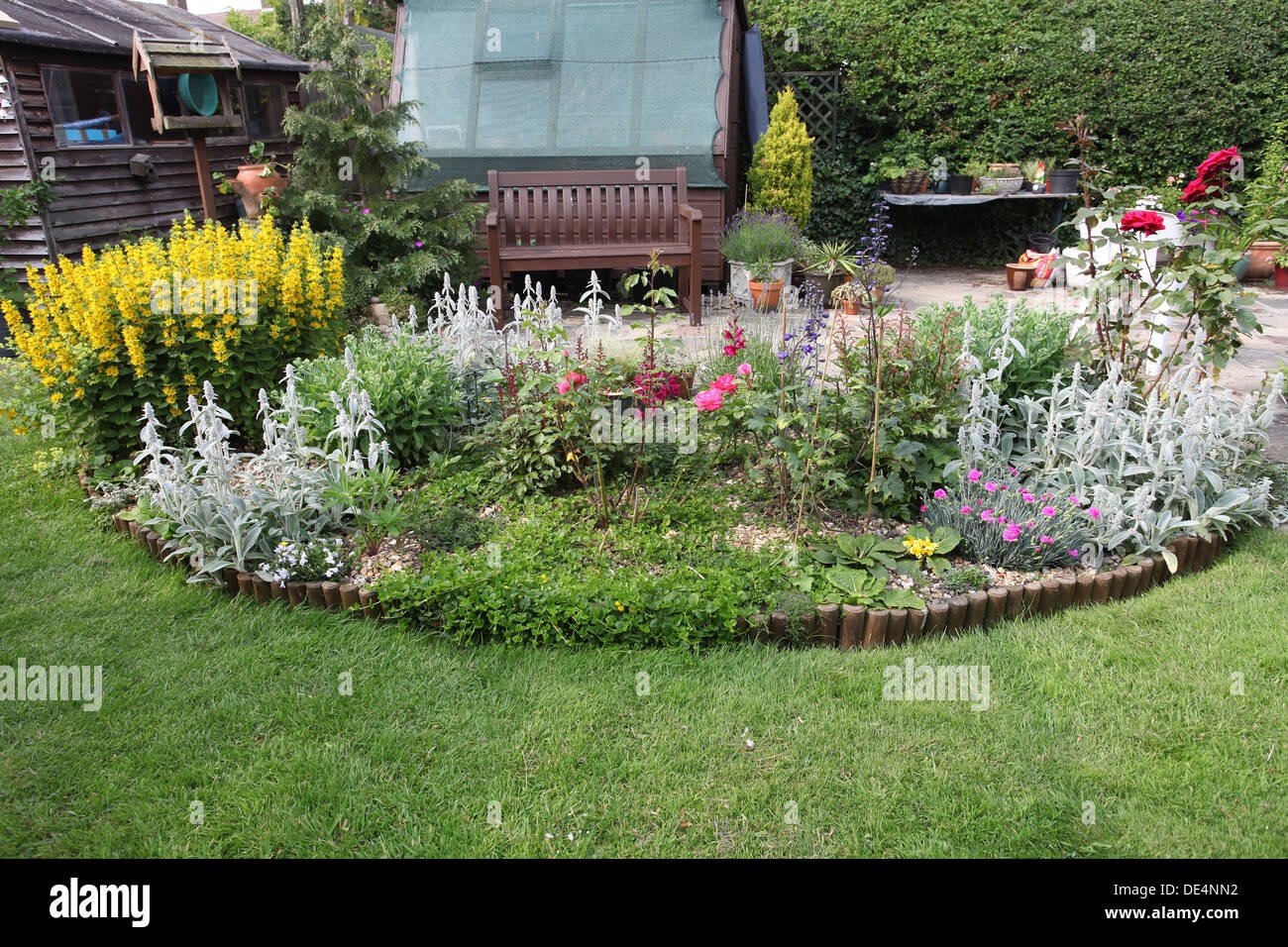 flower bed in half moon shape in english garden stock photo