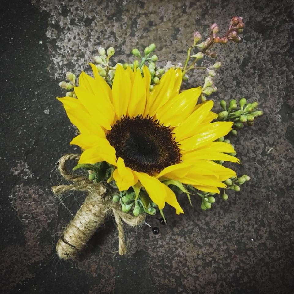 sunflower boutonniere with touches of seeded eucalyptus and twine