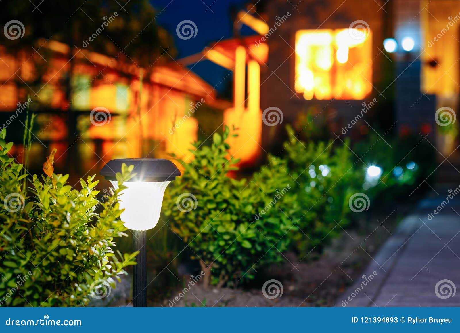 small solar garden light, lantern in flower bed. garden design